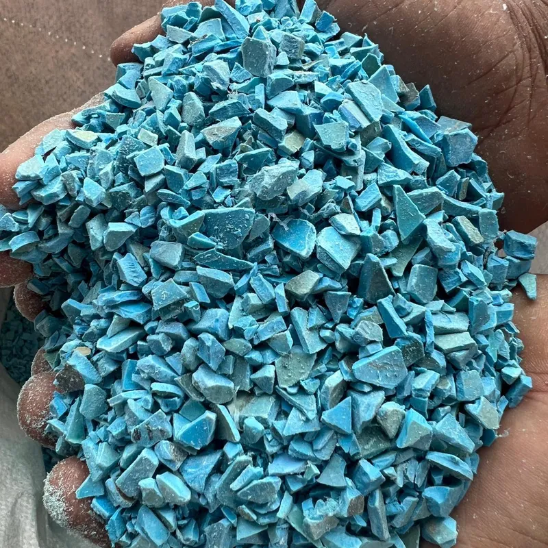 Handful of blue PVC pipe regrind