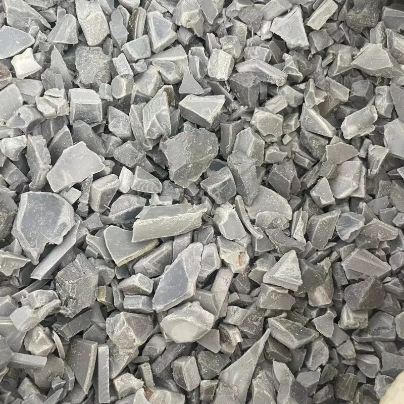 Grey PVC pipe regrind flakes, close-up