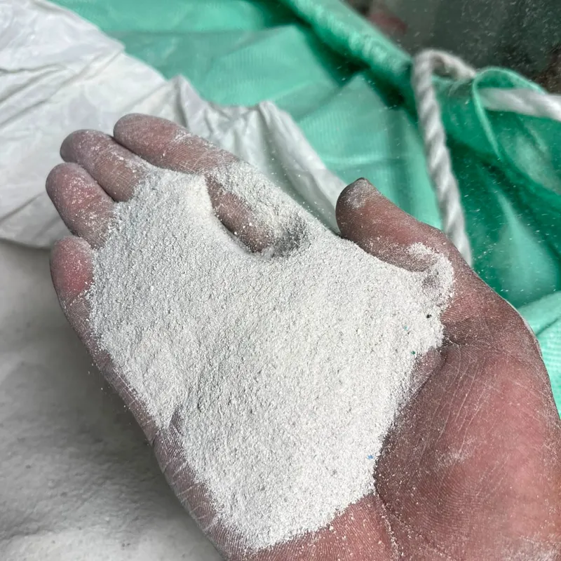 Hand holding white pulverised PVC pipe powder
