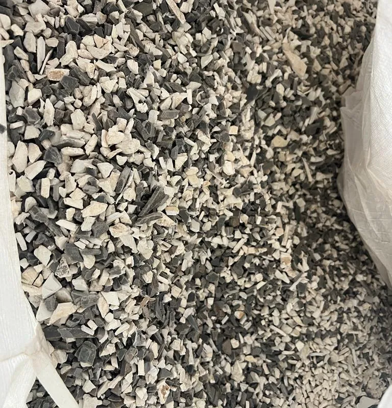 Grey and white PVC pipe regrind in a bulk bag