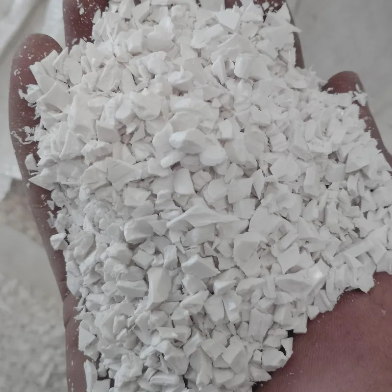 White PVC sheet regrind in an open hand