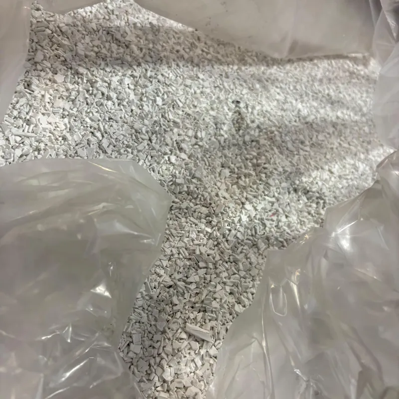 White PVC pipe regrind in an open bulk bag