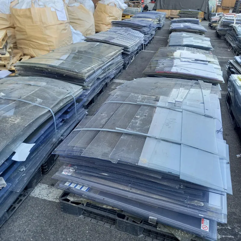 Rows of strapped stacks of PVC off-cut sheets in a yard