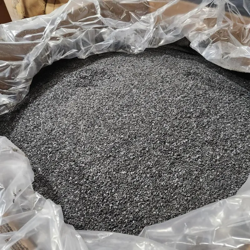Black PVC window profile regrind in an open bulk bag