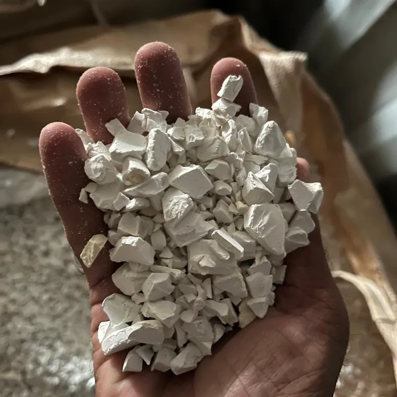 Off-white PVC pipe regrind in an open hand