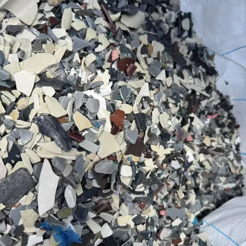Mixed-colour PVC regrind in an open bag, wider view