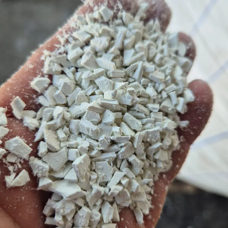 Handful of white PVC sheet regrind, closer view
